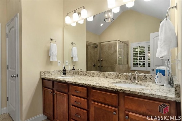 bathroom with vanity, an enclosed shower, and lofted ceiling