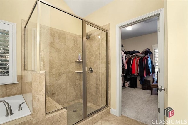 bathroom featuring tile patterned floors and independent shower and bath