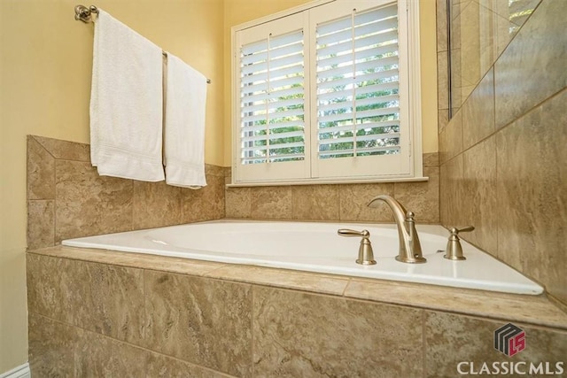 bathroom featuring a relaxing tiled tub