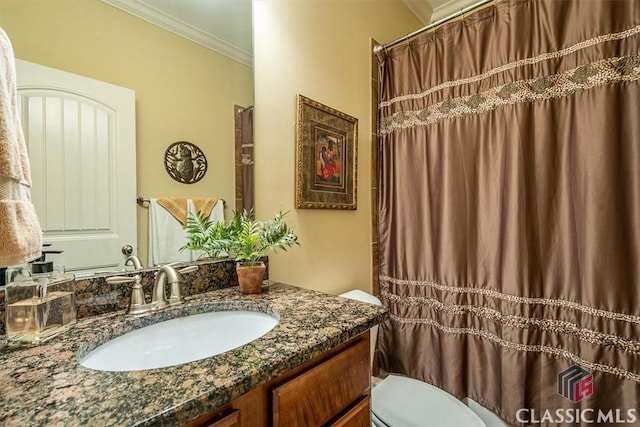 bathroom featuring crown molding, vanity, and toilet