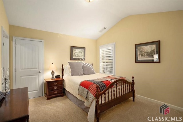 carpeted bedroom with vaulted ceiling