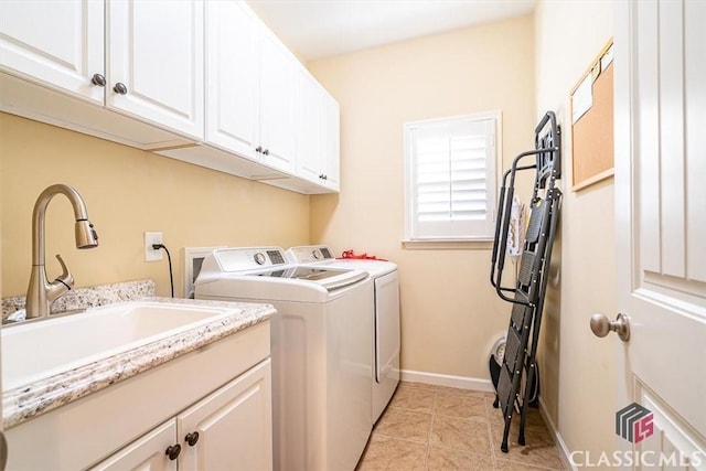 laundry room with separate washer and dryer, sink, light tile patterned floors, and cabinets