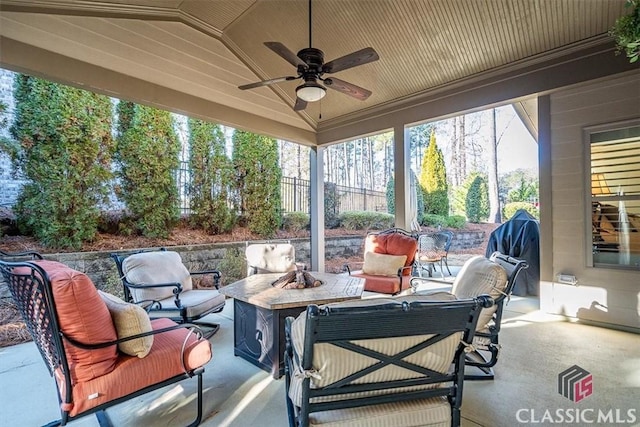 view of patio with an outdoor living space with a fire pit and ceiling fan