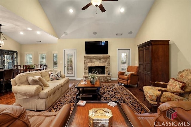 living room featuring a healthy amount of sunlight, a fireplace, and hardwood / wood-style floors