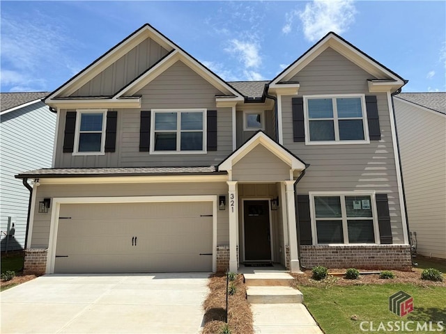 321 Ridge Pointe Dr, Athens, GA 30606 - view of front of home featuring board and batten siding, brick siding, driveway, and a garage