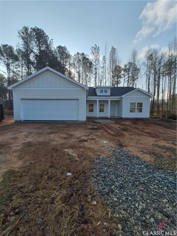 view of front of house with a garage, board and batten siding, and driveway