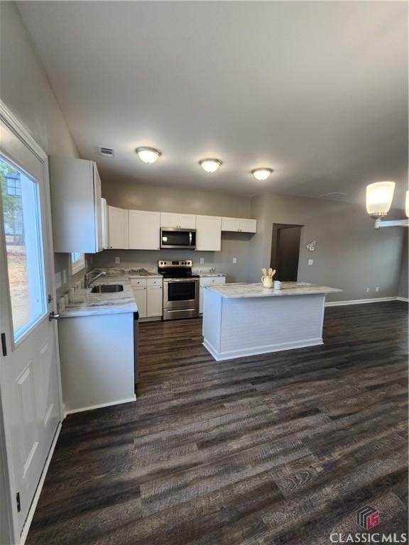 kitchen featuring white cabinetry, stainless steel appliances, dark hardwood / wood-style floors, and sink