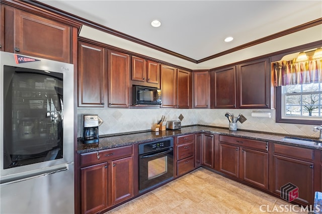 kitchen with backsplash, dark stone countertops, sink, and black appliances