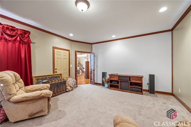 sitting room with crown molding and carpet flooring