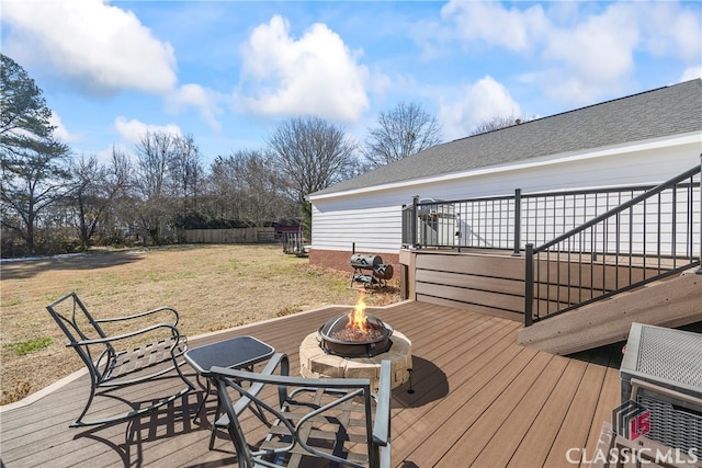 deck featuring a yard and a fire pit