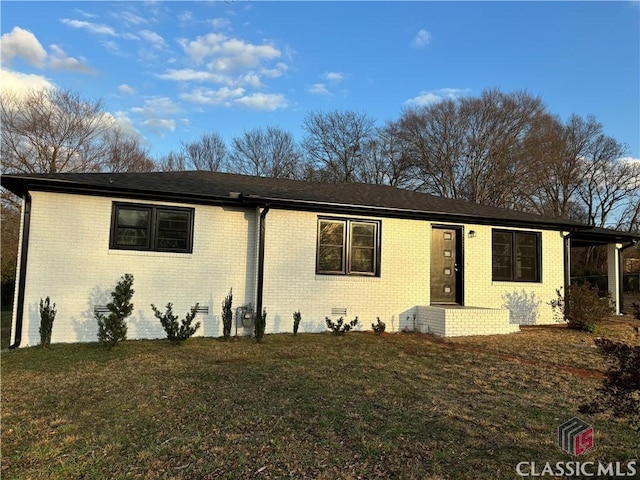 single story home with a front yard, crawl space, and brick siding