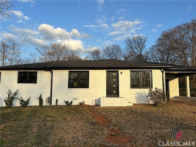 ranch-style home featuring a carport, a front yard, crawl space, and brick siding