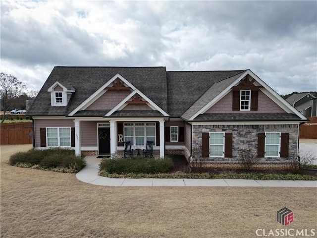 craftsman inspired home with a front lawn