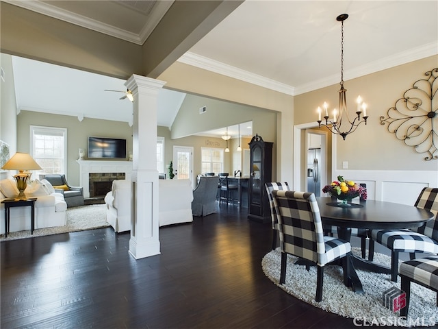 dining space with ceiling fan, dark wood-type flooring, decorative columns, and a healthy amount of sunlight