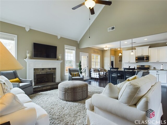 dining room with ceiling fan, dark wood-type flooring, plenty of natural light, and ornate columns