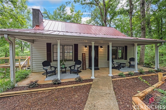 back of house featuring a porch