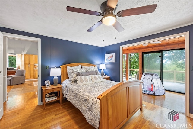 bedroom with light hardwood / wood-style flooring, ceiling fan, access to outside, and a textured ceiling