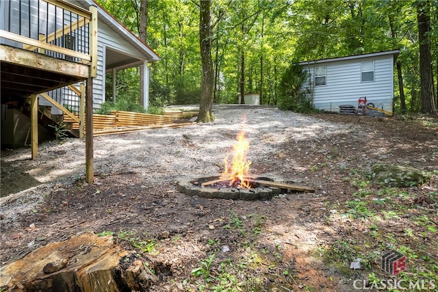 view of yard with a fire pit