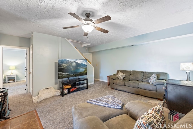 carpeted living room with ceiling fan and a textured ceiling