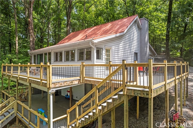 rear view of property featuring a wooden deck