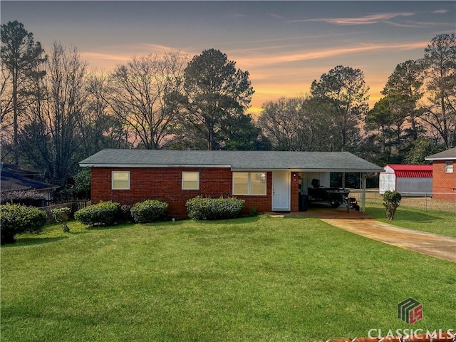 ranch-style house with a carport and a yard