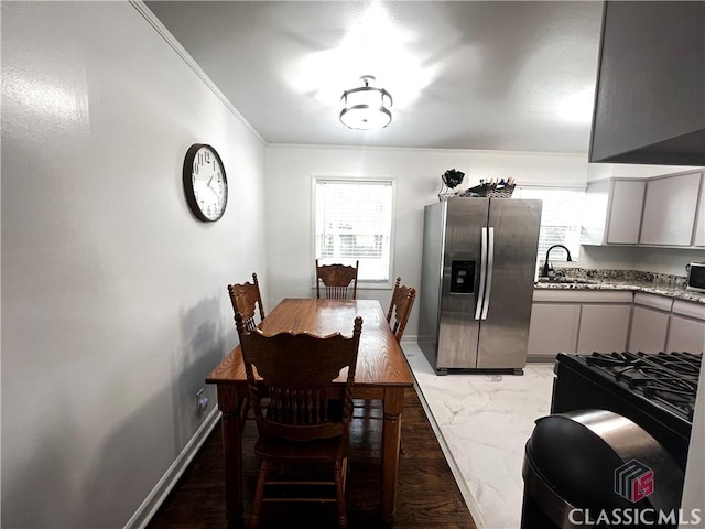 dining area featuring ornamental molding and sink