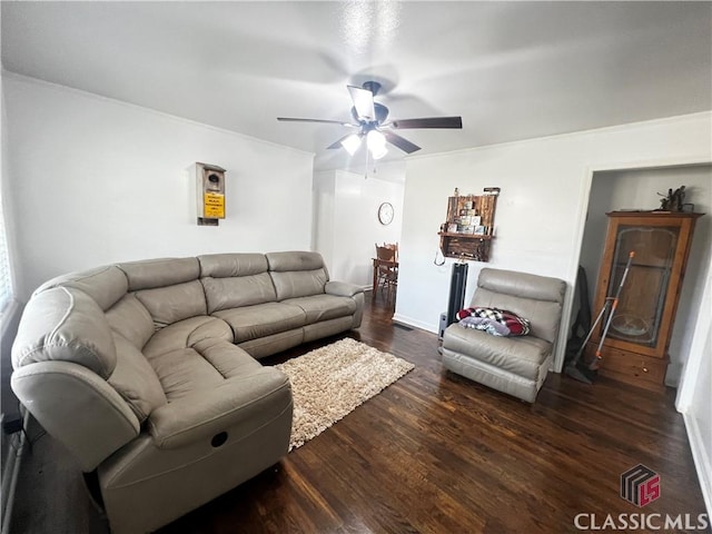 living room featuring dark hardwood / wood-style flooring and ceiling fan