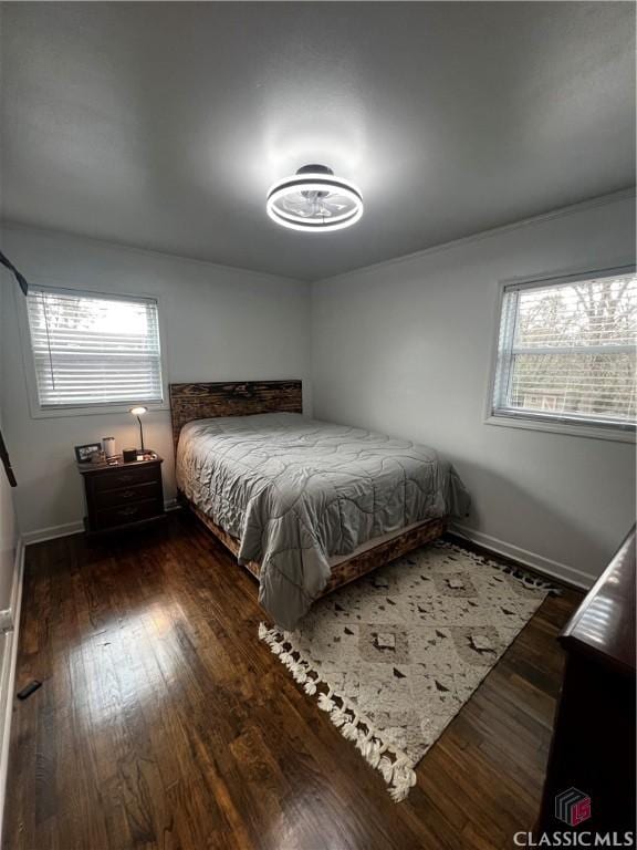 bedroom with dark hardwood / wood-style floors