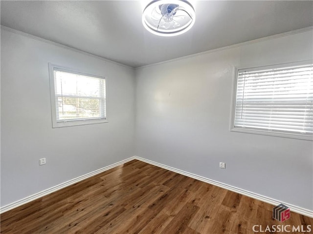 unfurnished room featuring crown molding and wood-type flooring