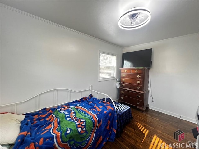 bedroom featuring dark hardwood / wood-style flooring and crown molding