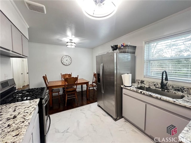 kitchen with sink, crown molding, stainless steel appliances, and light stone countertops