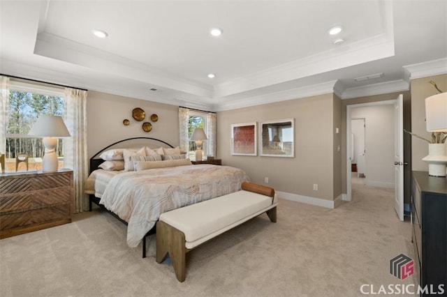 carpeted bedroom featuring crown molding and a tray ceiling