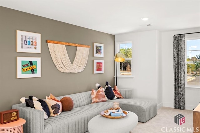 carpeted living room featuring a wealth of natural light