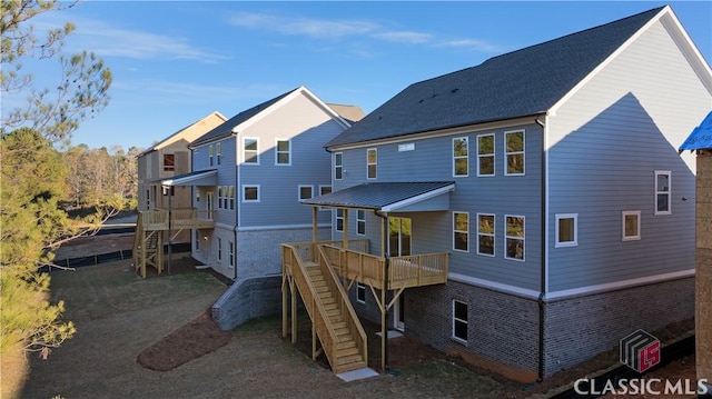 rear view of house featuring a deck