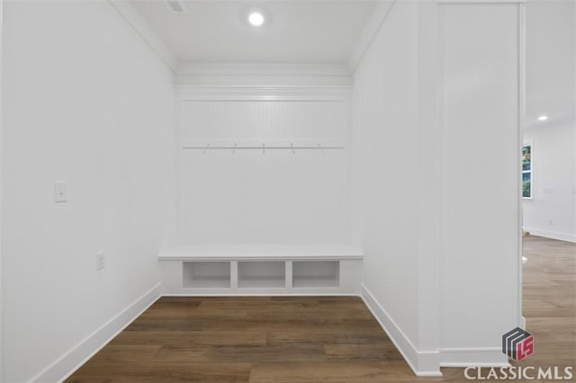 mudroom with ornamental molding and dark hardwood / wood-style floors