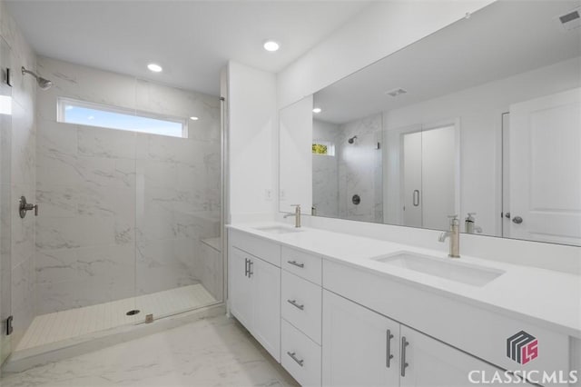 bathroom featuring vanity and a shower with shower door