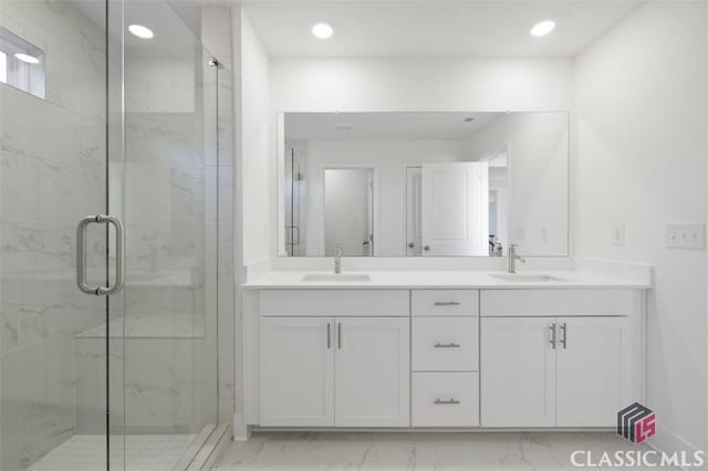 bathroom with walk in shower and vanity