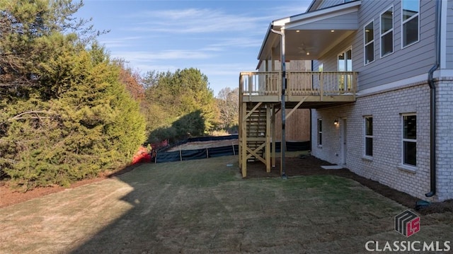 view of yard featuring a deck and a trampoline