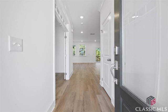 corridor with light hardwood / wood-style floors