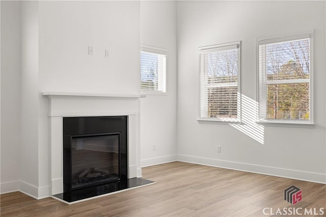 unfurnished living room with light wood-type flooring