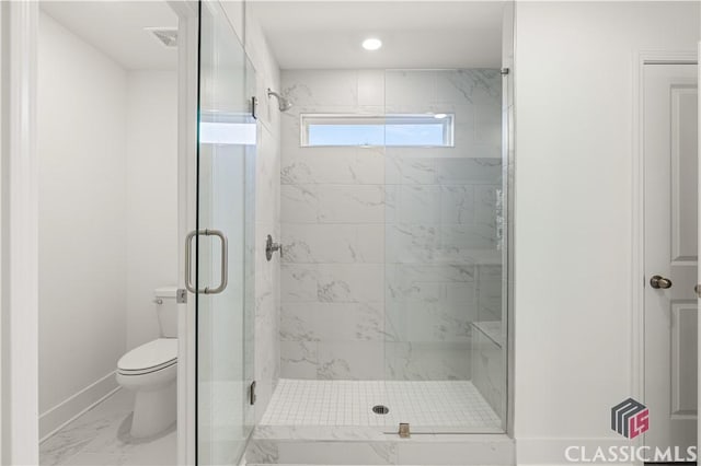 bathroom featuring an enclosed shower and toilet