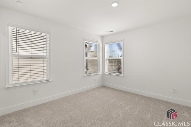 spare room with light colored carpet