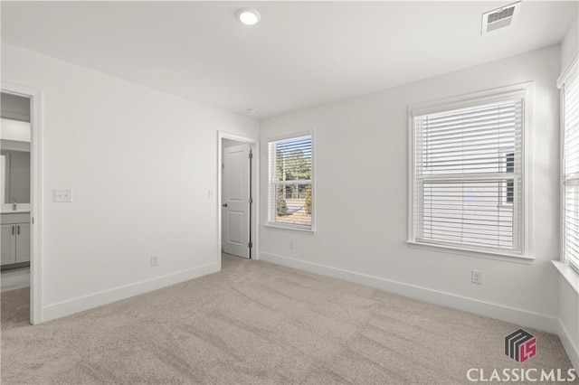 unfurnished room featuring light colored carpet