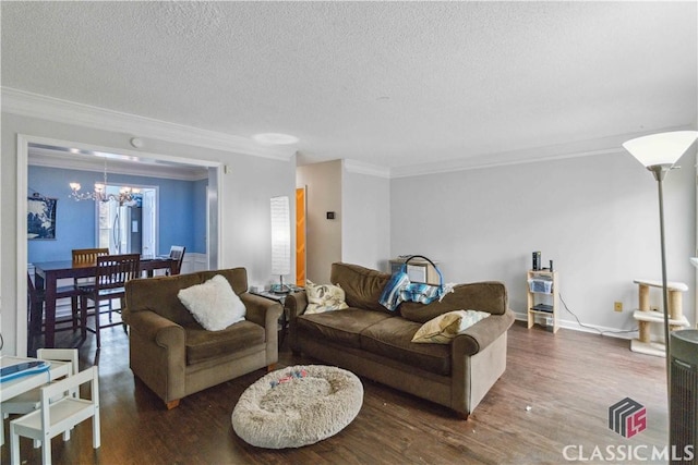 living room featuring crown molding, a chandelier, a textured ceiling, and dark hardwood / wood-style flooring