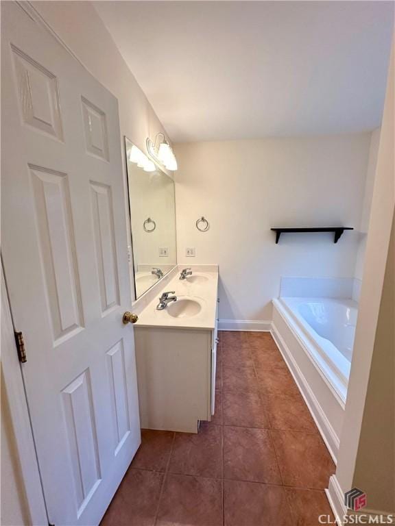 bathroom featuring vanity, a bath, and tile patterned floors