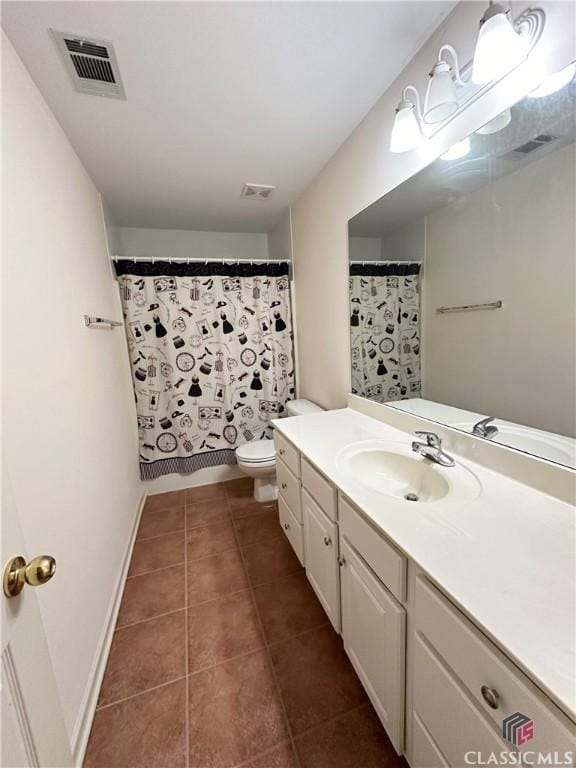 bathroom featuring tile patterned floors, toilet, a shower with shower curtain, and vanity