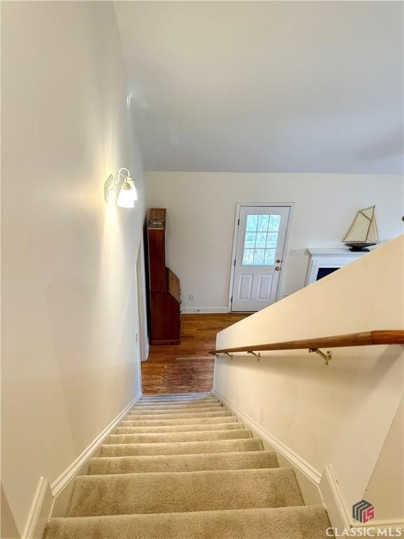 stairs with hardwood / wood-style flooring