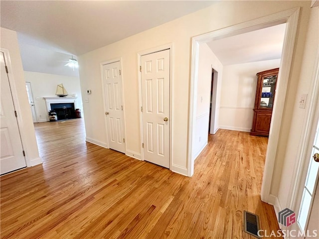 hallway with light hardwood / wood-style floors