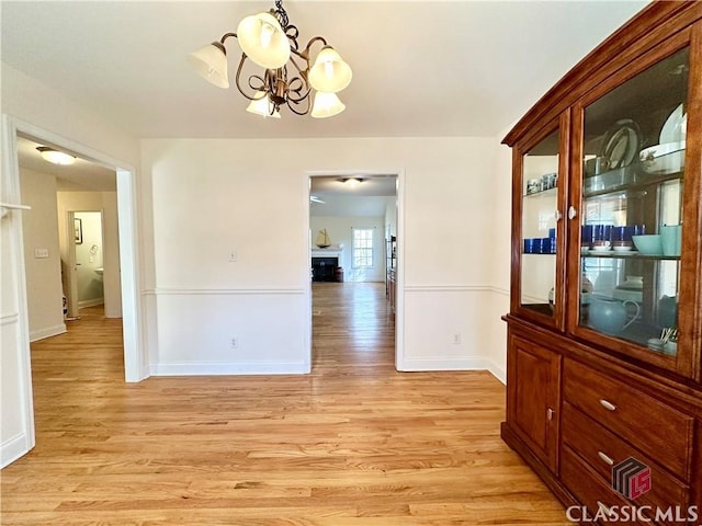 dining space with a chandelier and light wood-type flooring