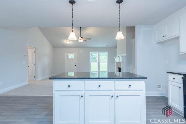 kitchen with white cabinetry, hanging light fixtures, and a center island